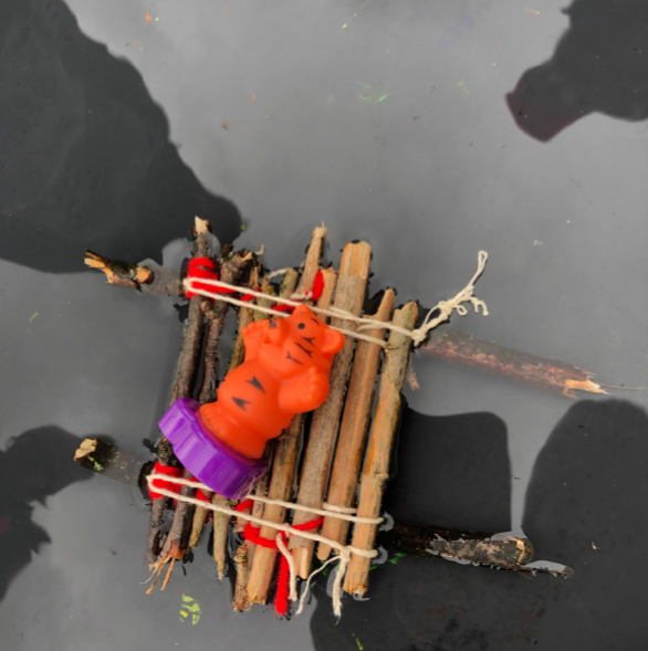 Image of a small raft made of sticks and string on water