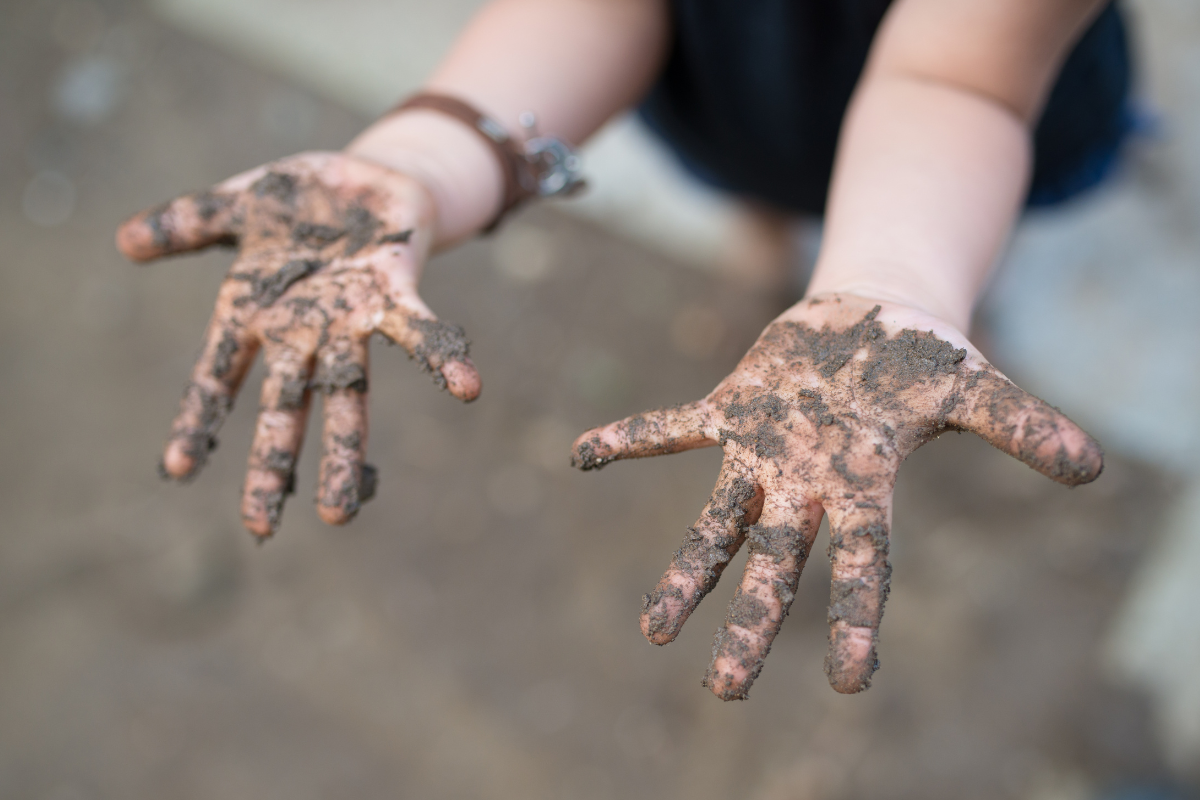 A child's muddy hands