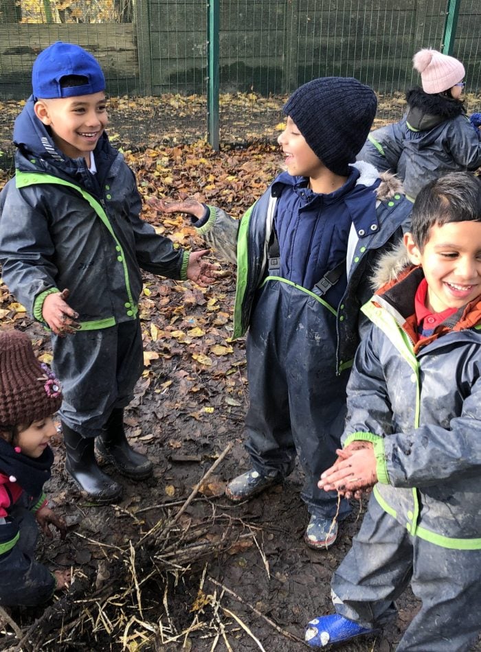 children smiling enjoying exploring outdoors in autumn