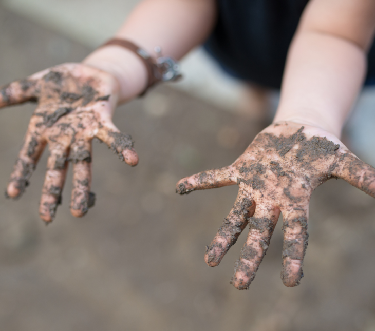 A child's muddy hands