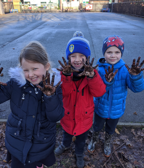 3 children with muddy hands