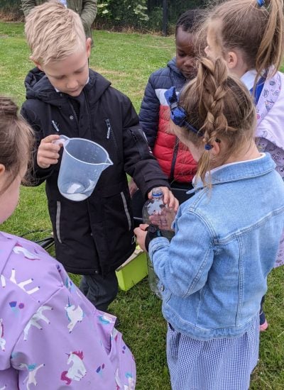 Children applying capacity skills to measuring water in a jug