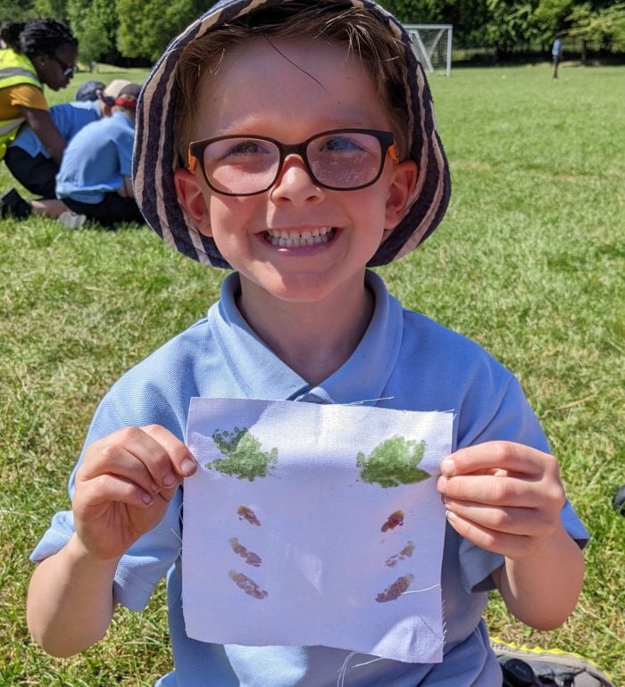 A child holding up a symmetrical flag he made