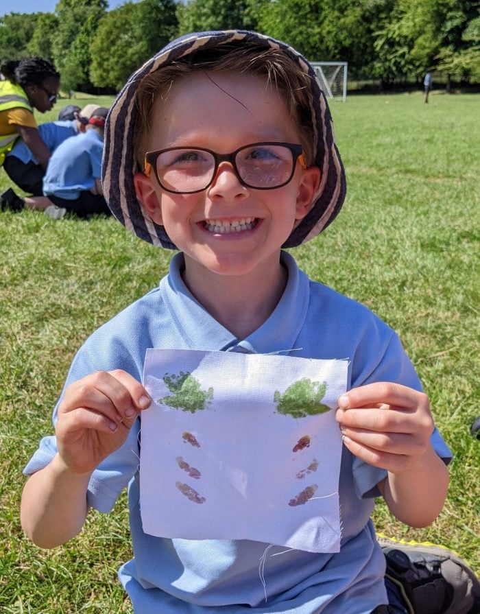 A child holding up a symmetrical flag he made