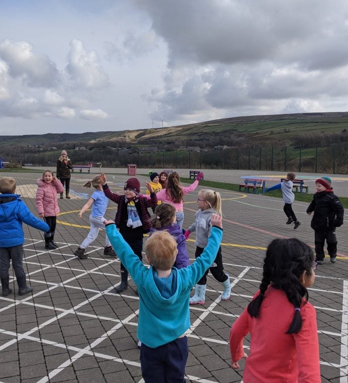 a class playing fire tig during an outdoor workshop